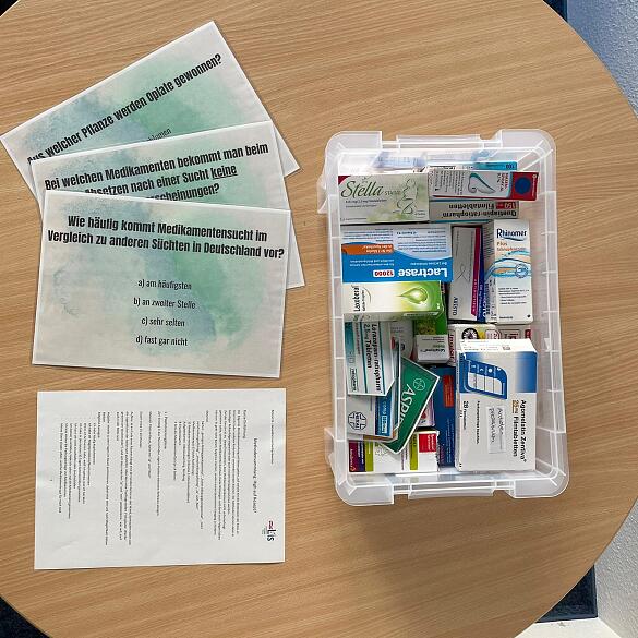 Plastikkiste mit unterschiedlichen Medikamentenverpackungen, Aktionskarten und Anleitung Plastikkiste mit unterschiedlichen Medikamentenverpackungen, Aktionskarten und Anleitung