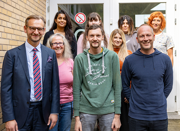 Ausbilder und Auszubildende vor dem Eingang des LIS