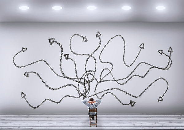 Mensch vor Wand mit Pfeilen